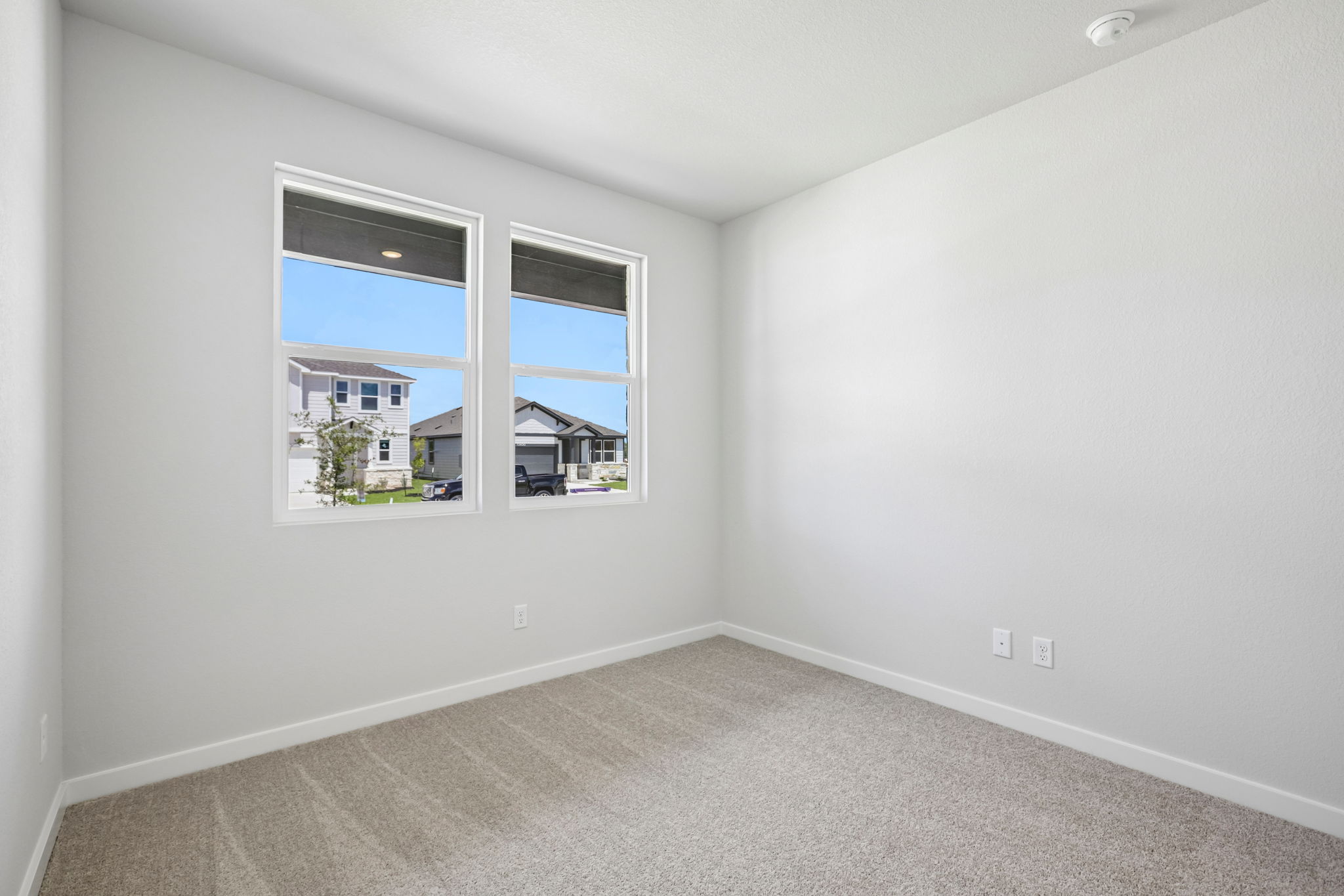 A room with a window and a carpet.
