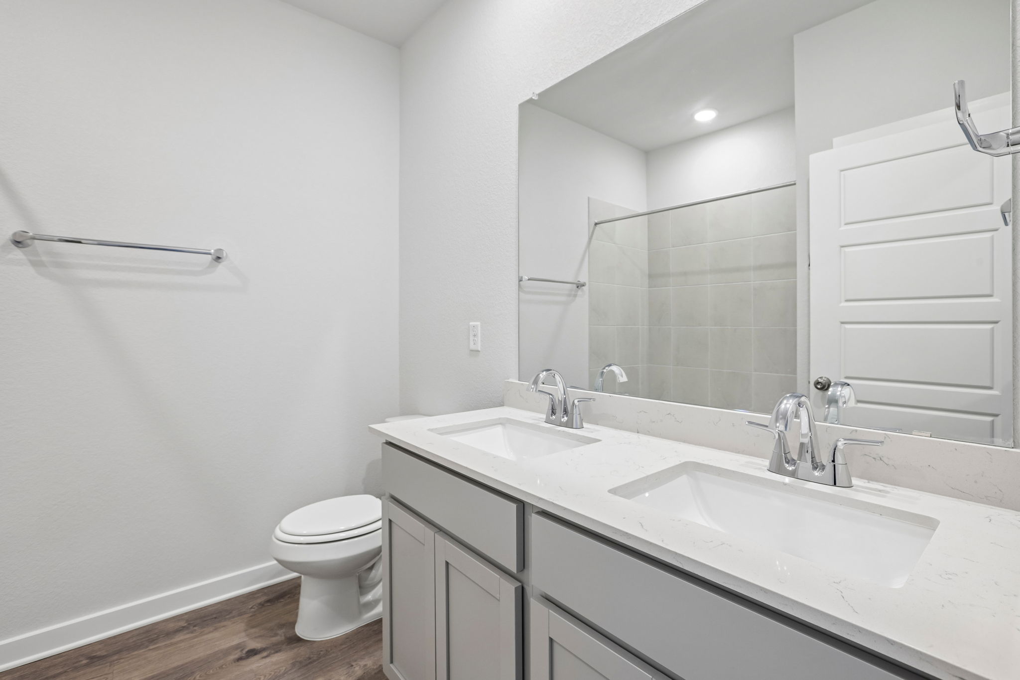 A bathroom with a large mirror.
