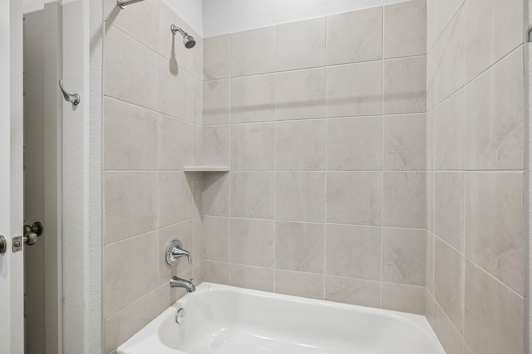 A bathtub in a bathroom.