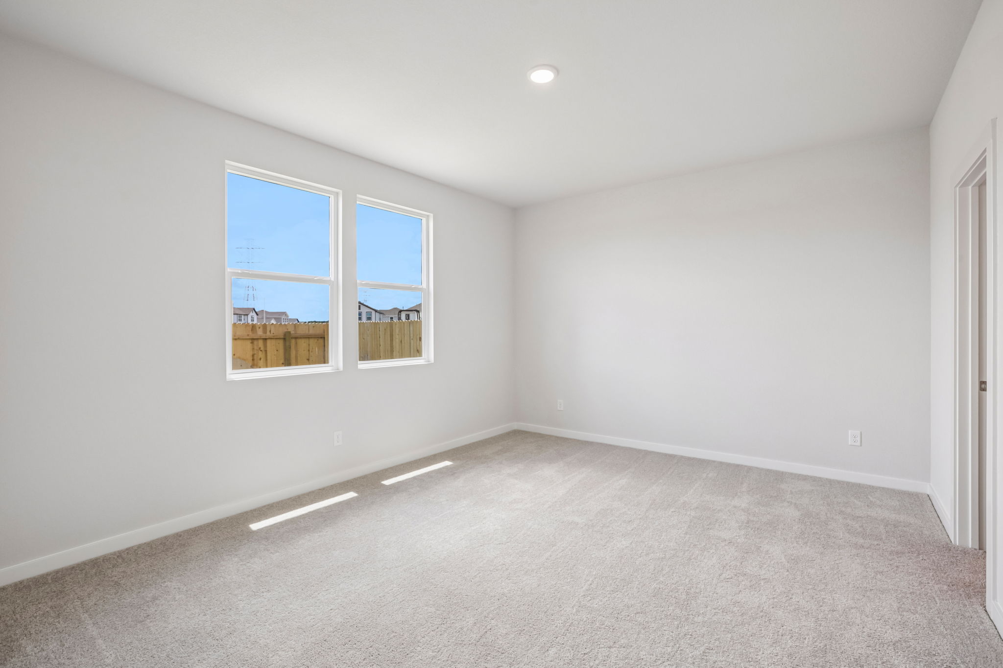 A room with a window and a carpet.