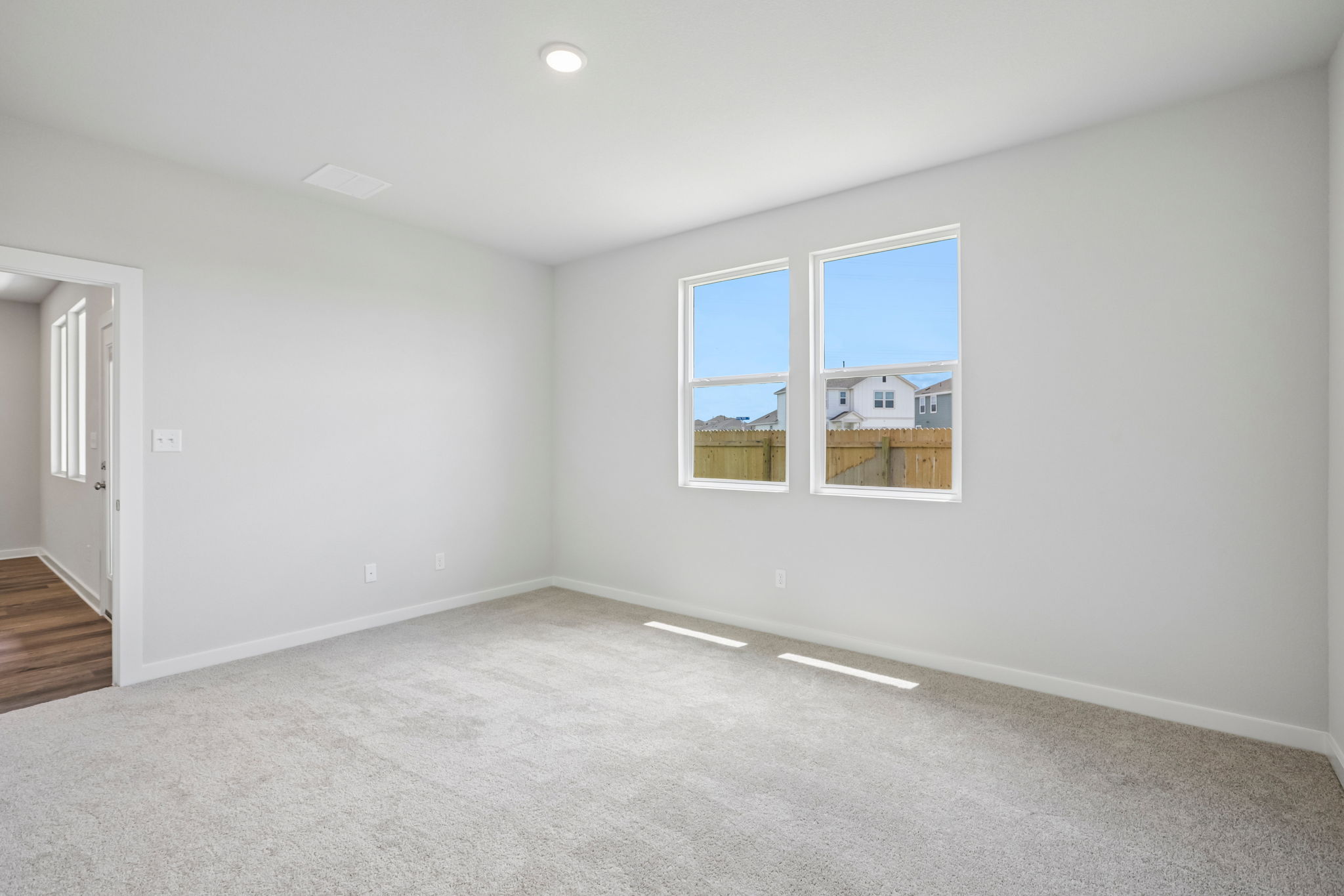 A room with a window and a door.