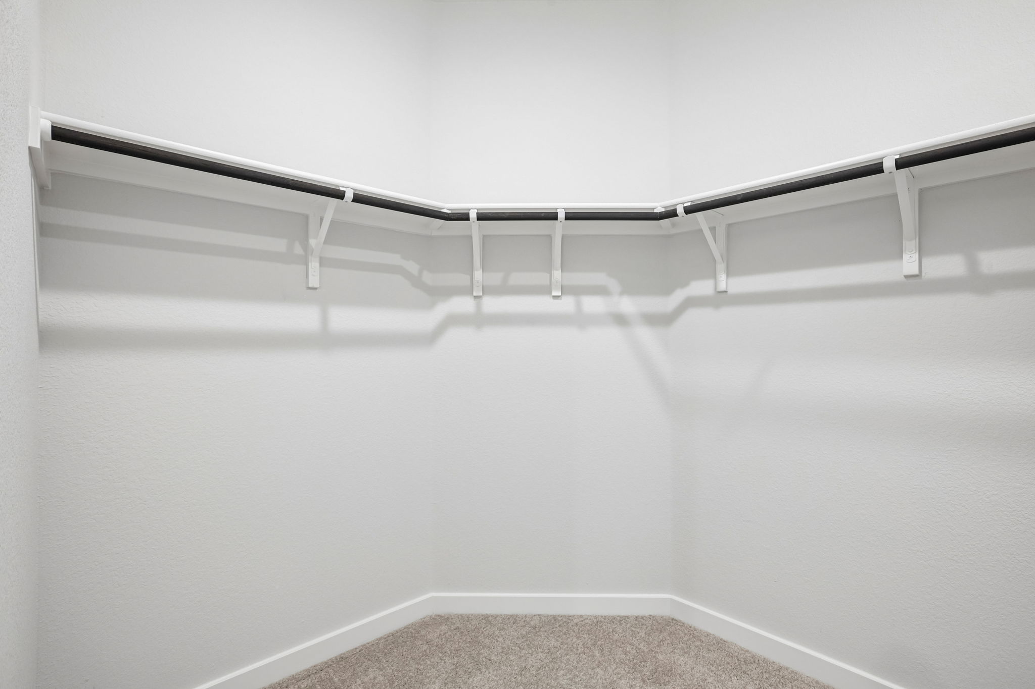 A metal railing on a white wall.