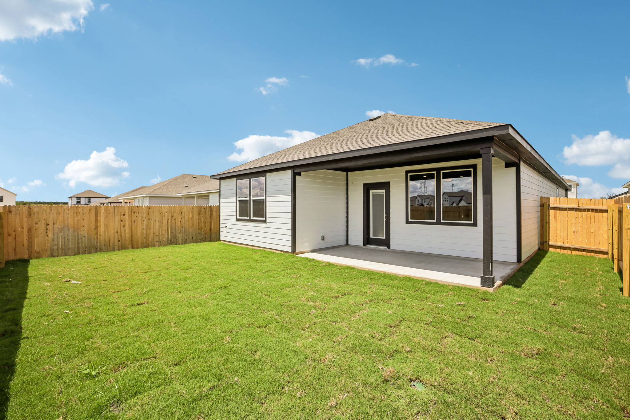 A small house in a grassy yard.
