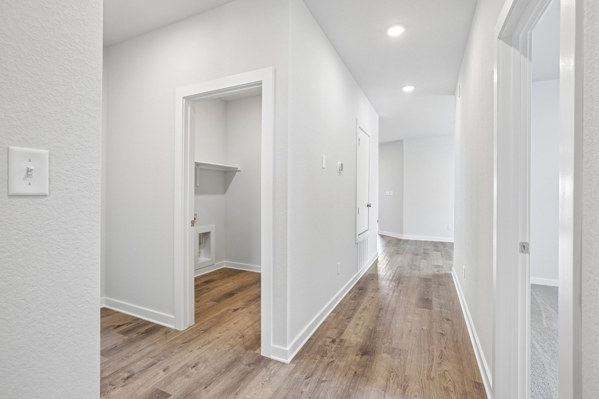 A hallway with white walls.