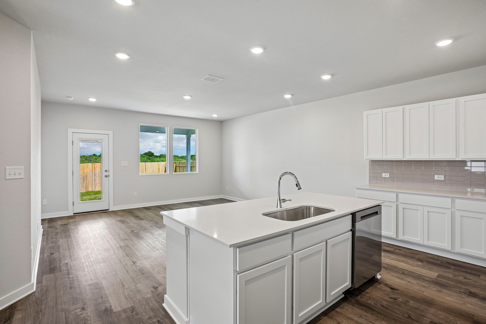 A kitchen with white cabinets.