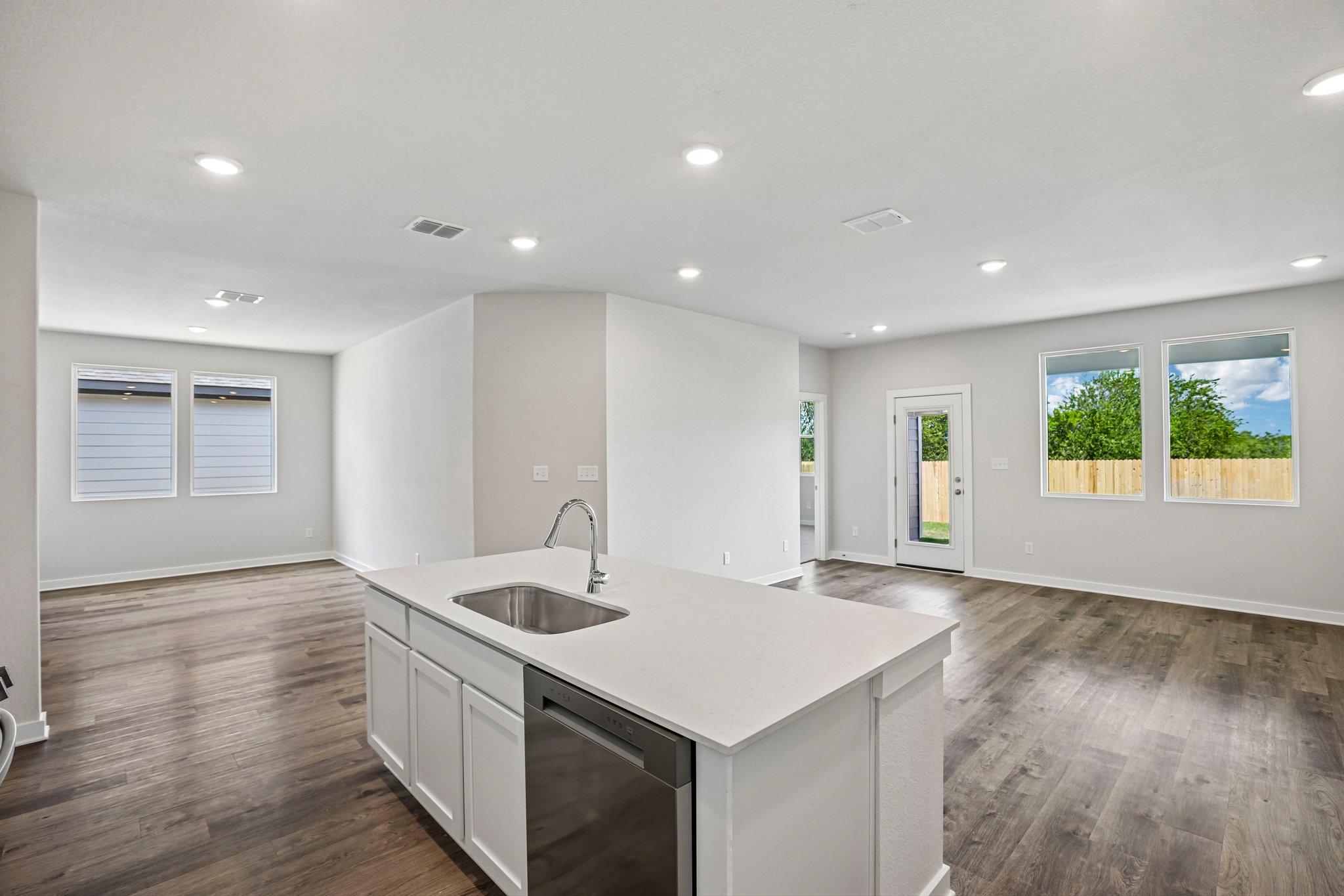 A kitchen with white cabinets.