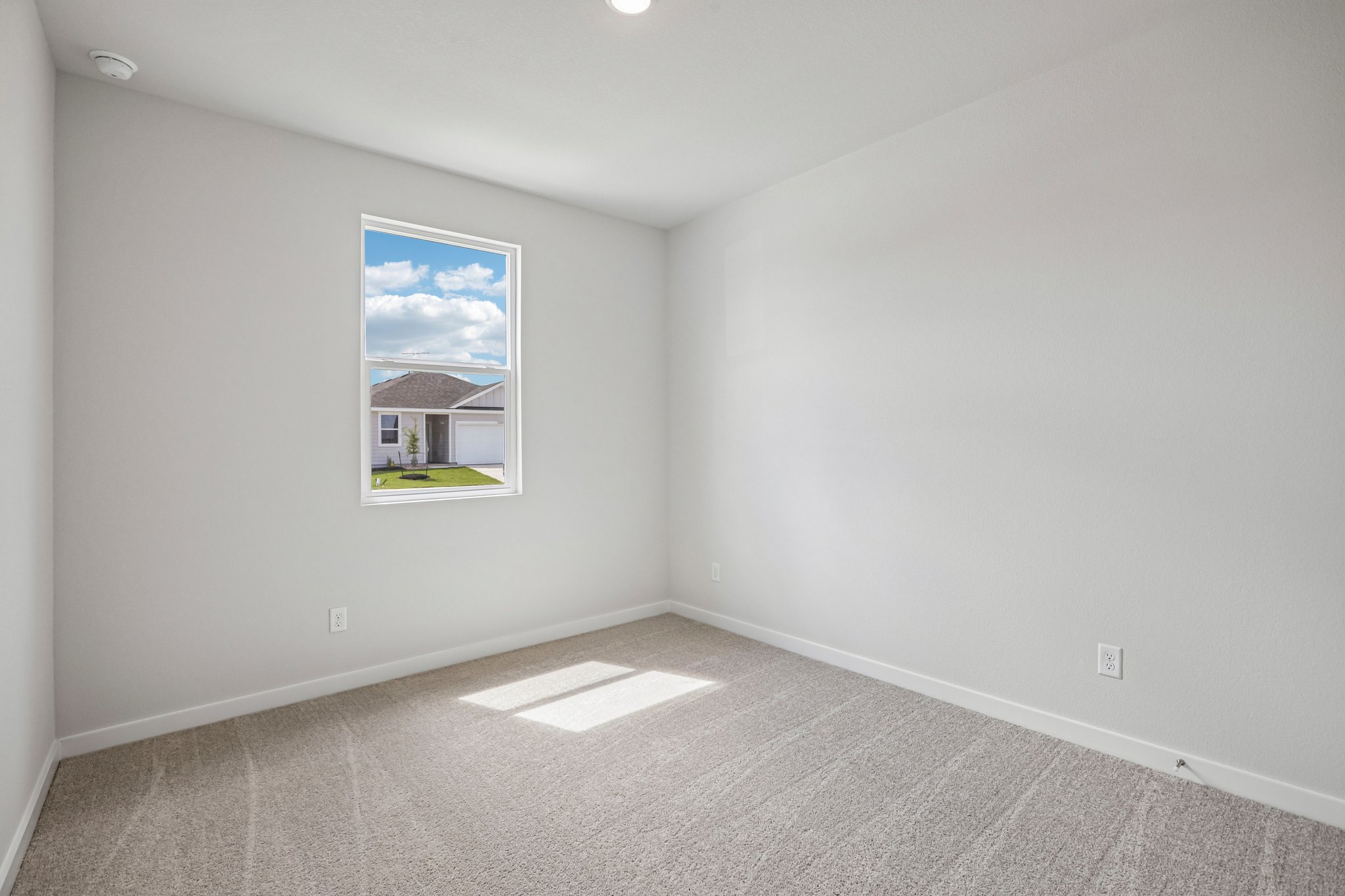 A white room with a painting on the wall.