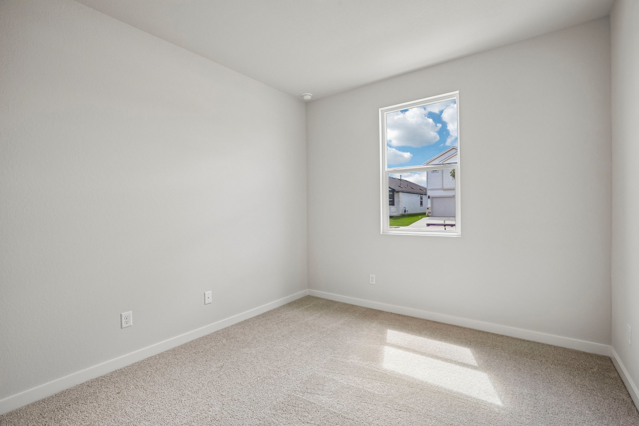 A white room with a painting on the wall.