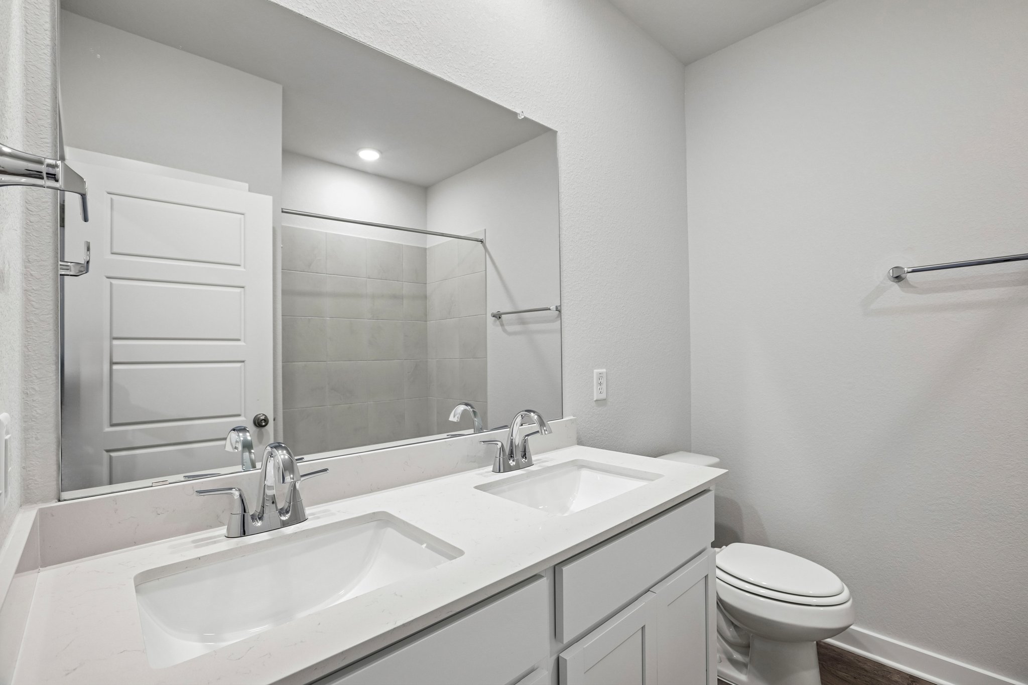 A bathroom with a large mirror.