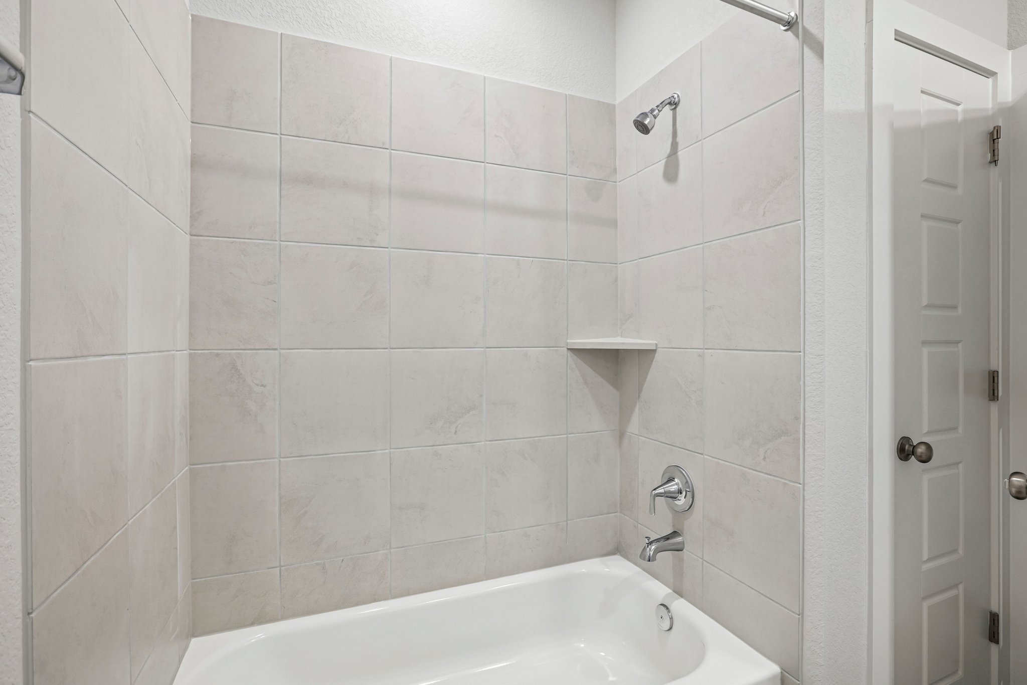 A bathroom with a bathtub and toilet.
