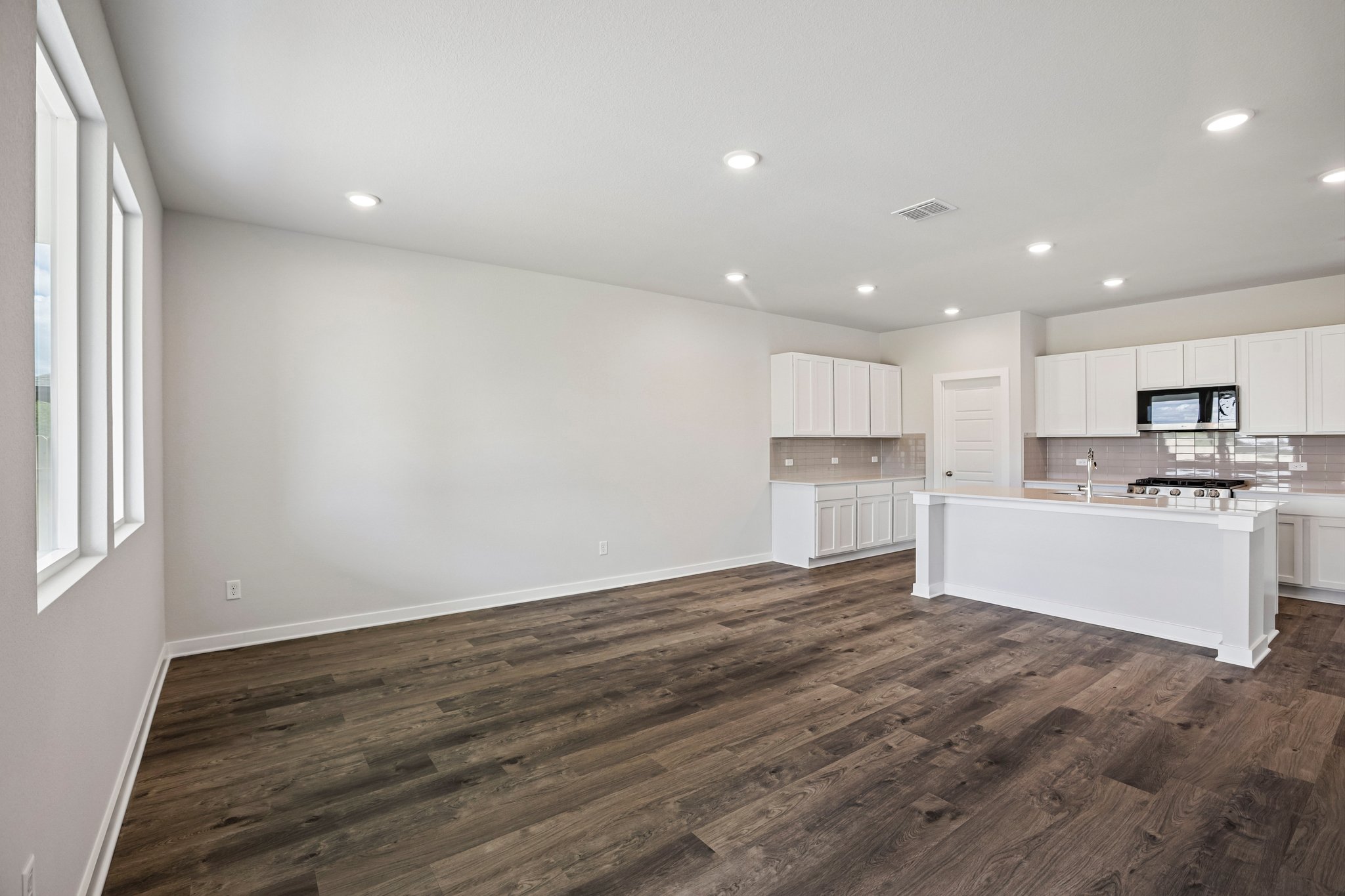 A large kitchen with white cabinets.