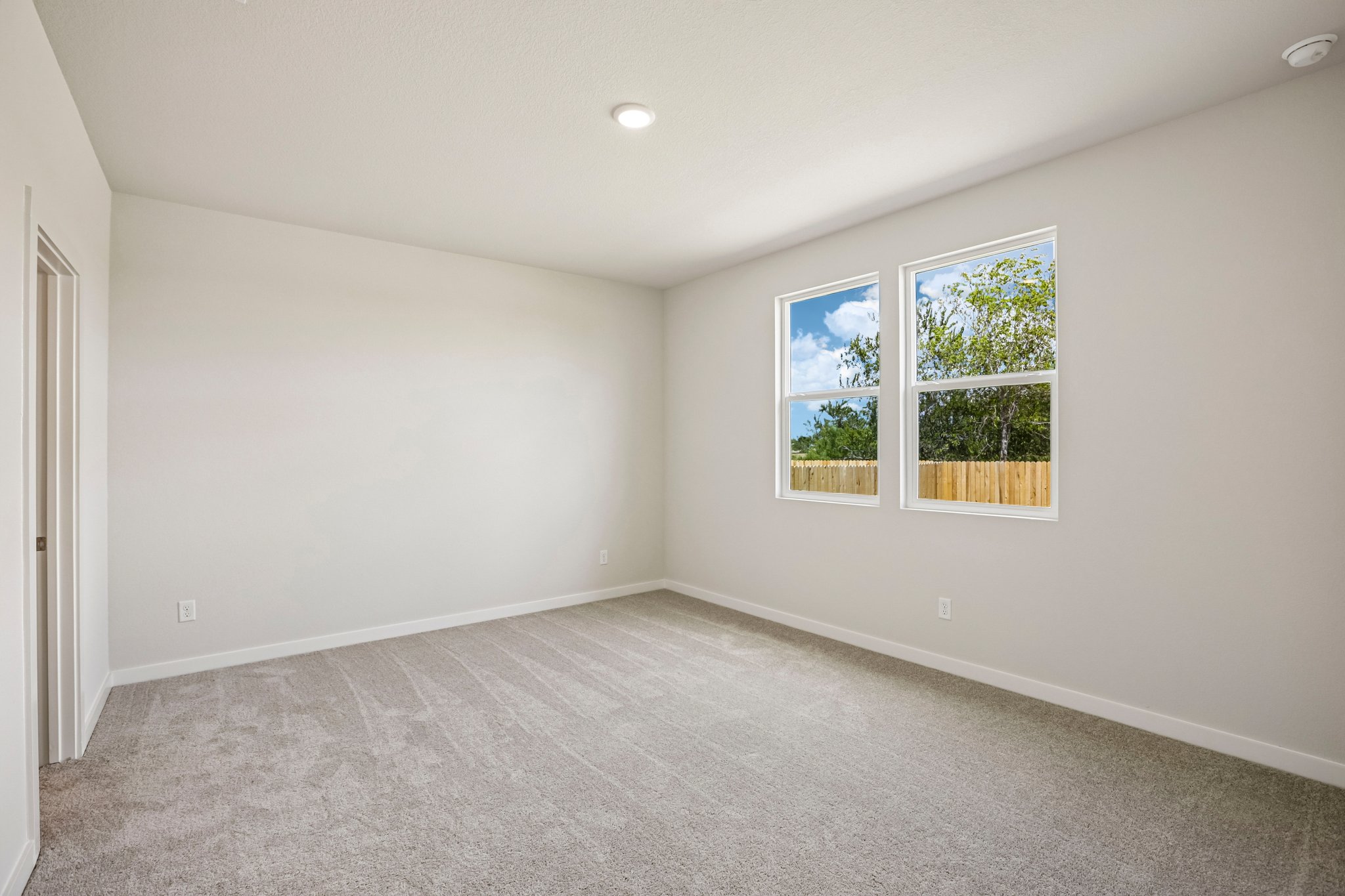 A room with a window and a door.