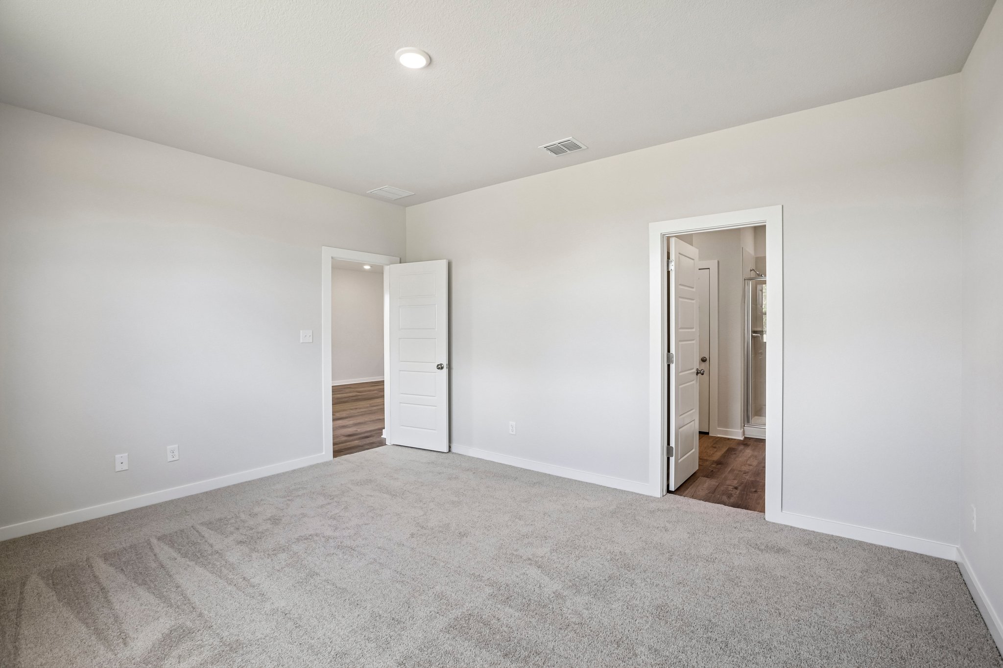 A hallway with white walls.