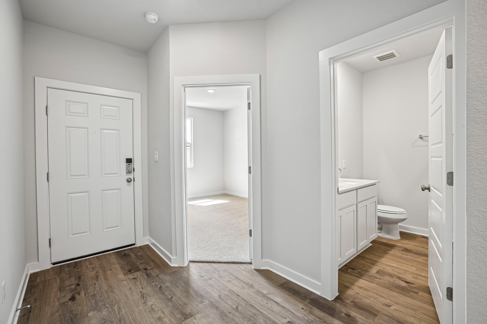 A bathroom with white doors.