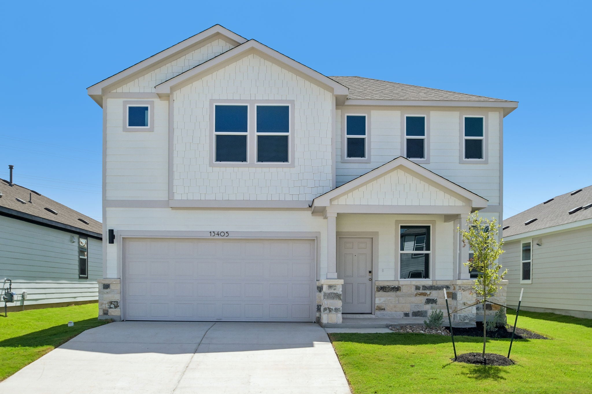 A white house with a garage.