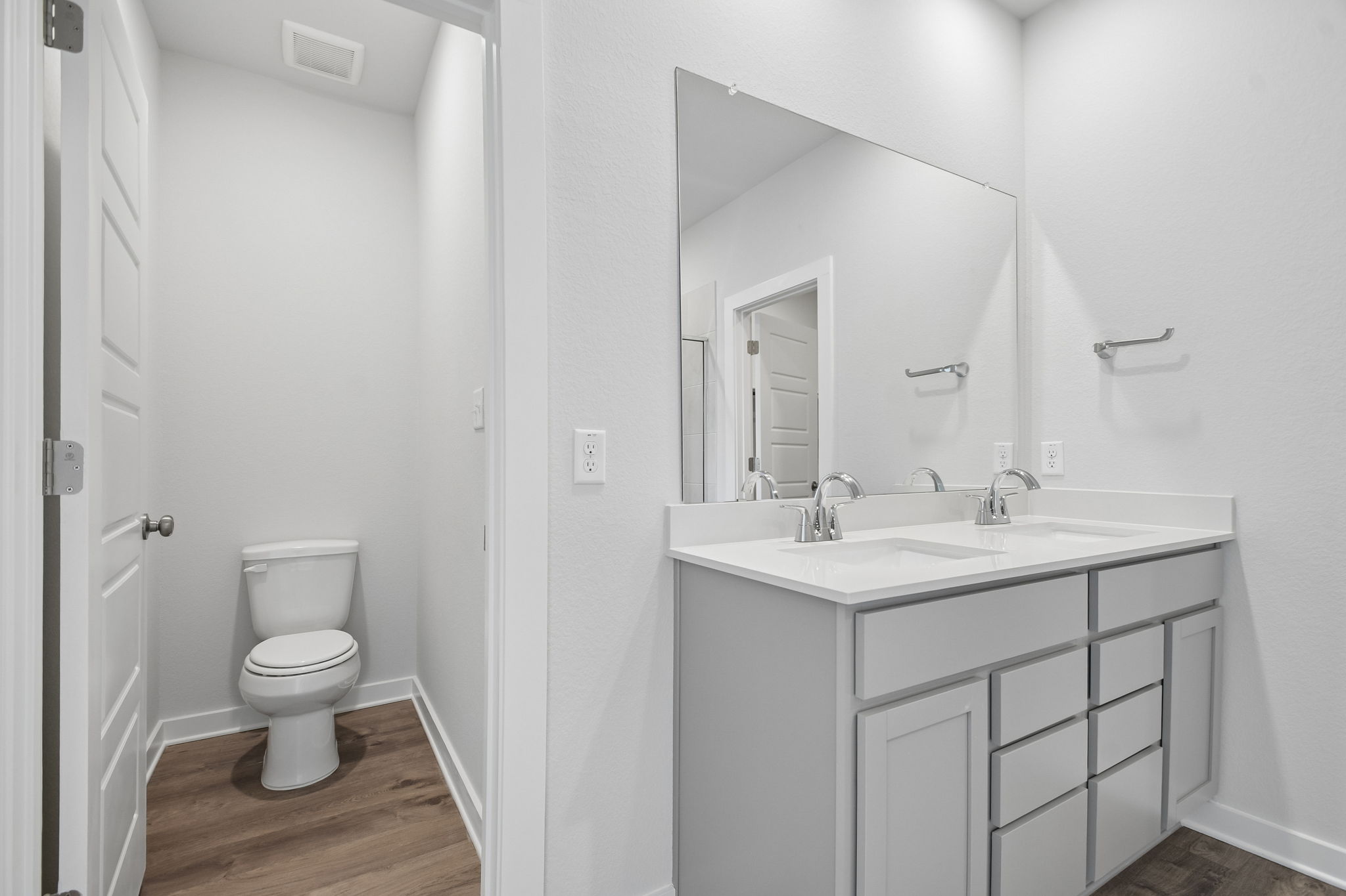 A bathroom with a toilet and sink.