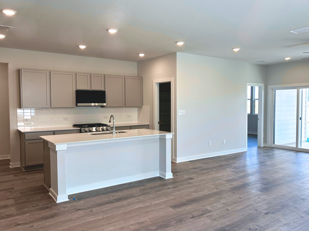 A kitchen with white cabinets.