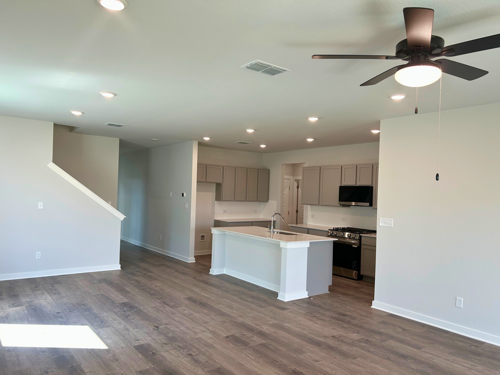 A kitchen with white cabinets.