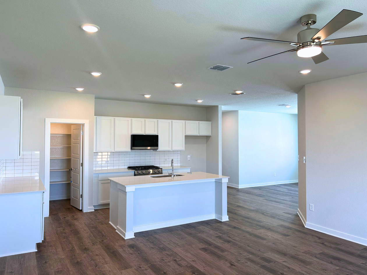 A kitchen with white cabinets.