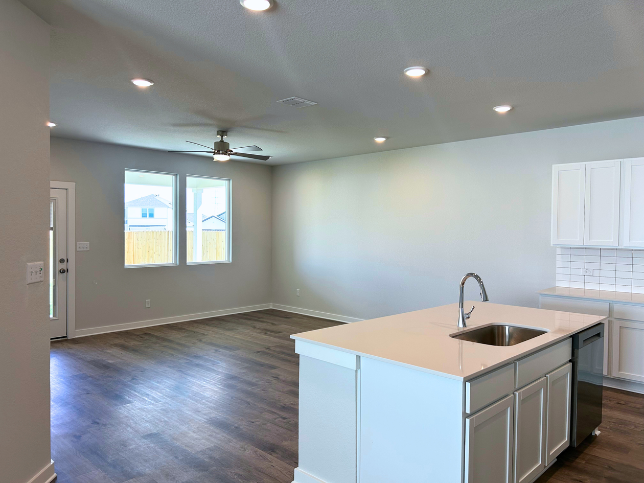 A kitchen with white cabinets.