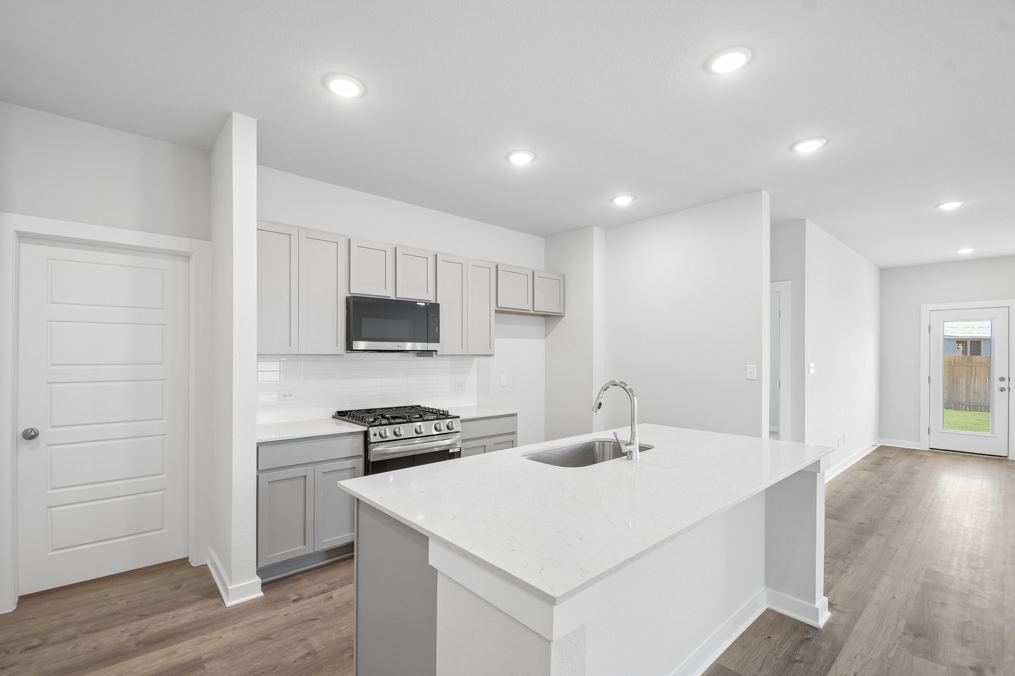 A kitchen with white cabinets.