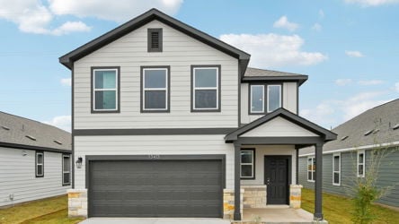 A grey house with a garage.
