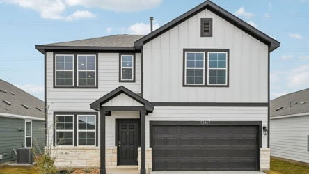 A grey house with a garage.