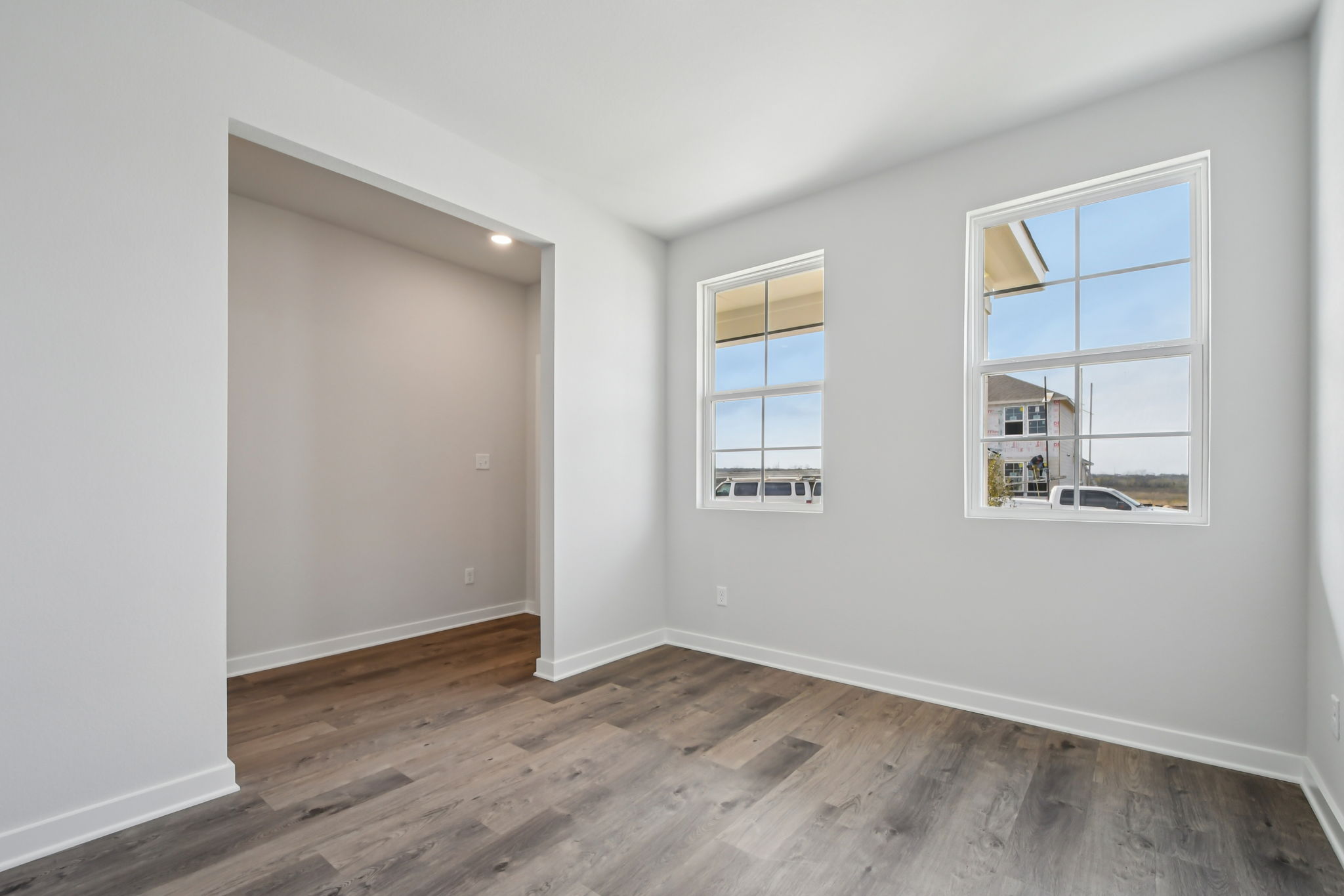 A room with a wood floor and a window.