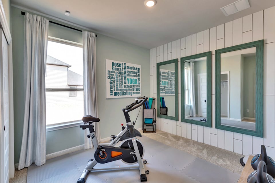 A room with a scooter and a window.