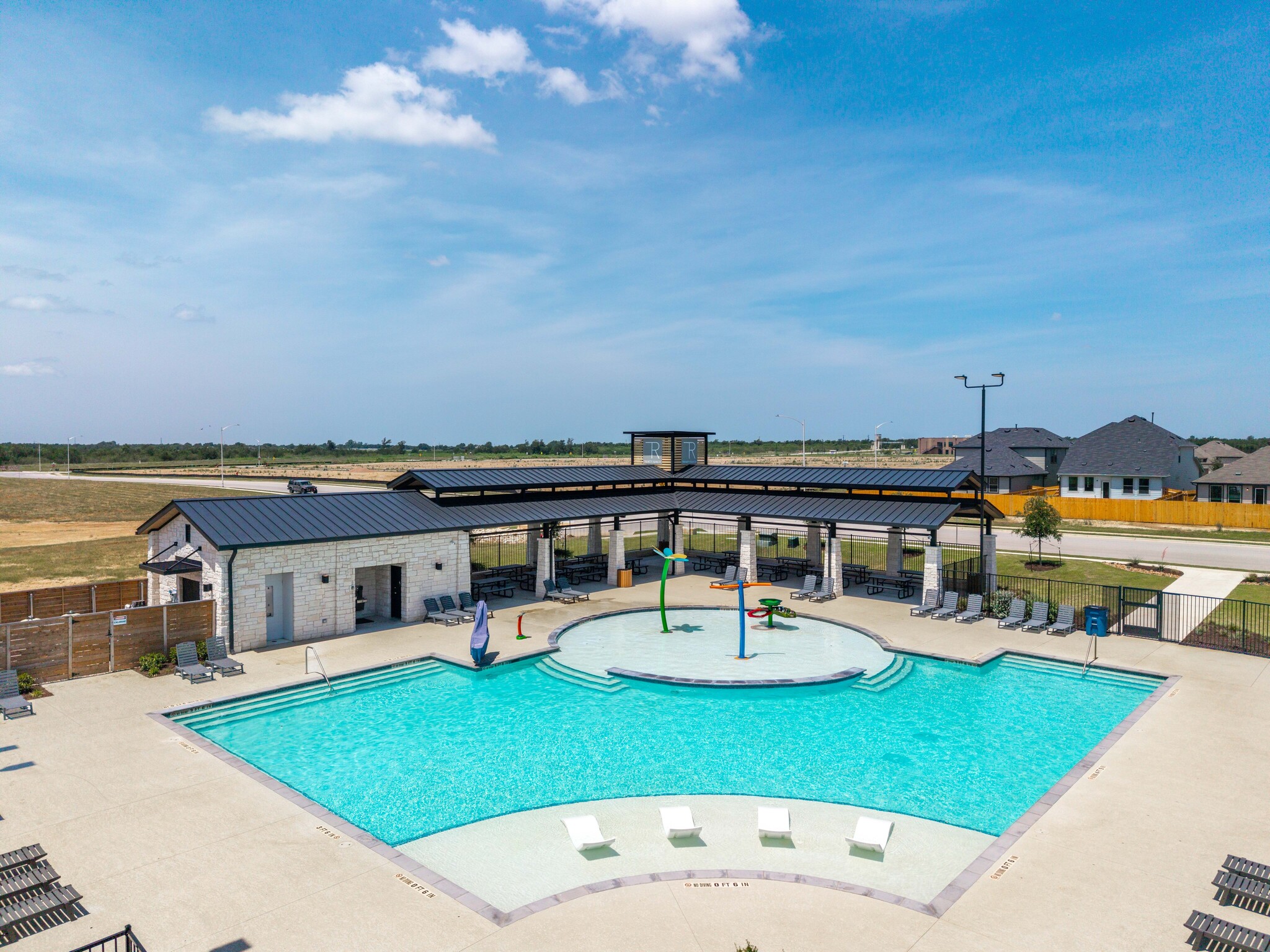 A swimming pool with a building in the background.