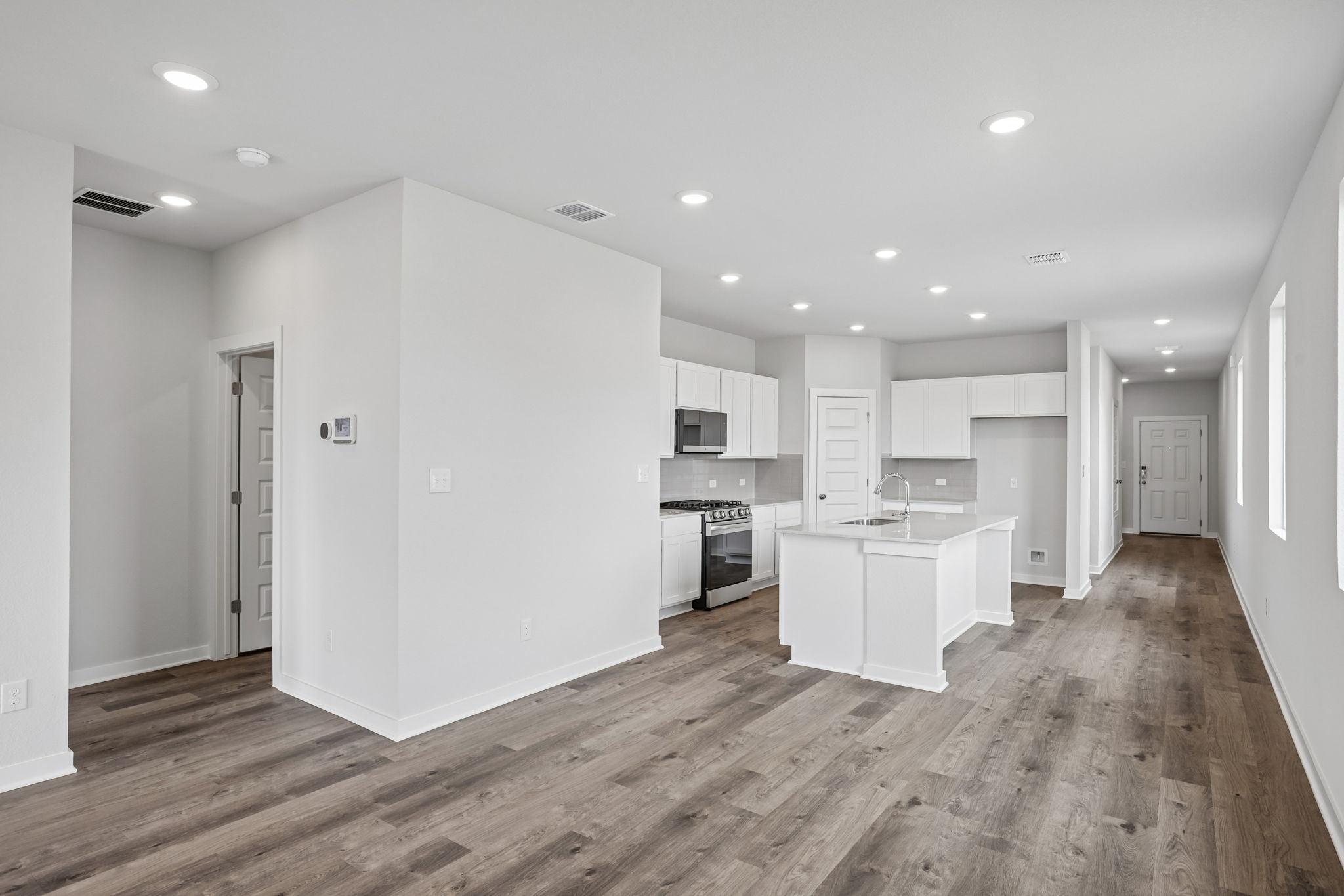 A large kitchen with white cabinets.