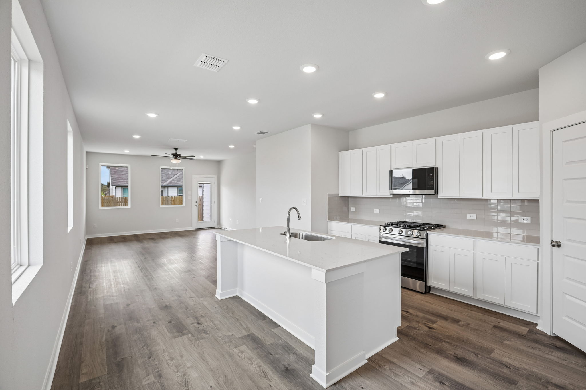 A kitchen with white cabinets.