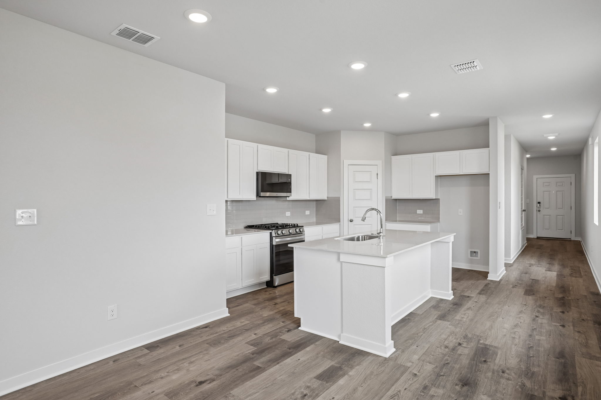 A kitchen with white cabinets.