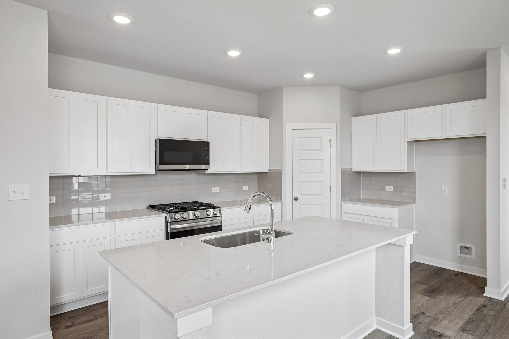 A kitchen with white cabinets.