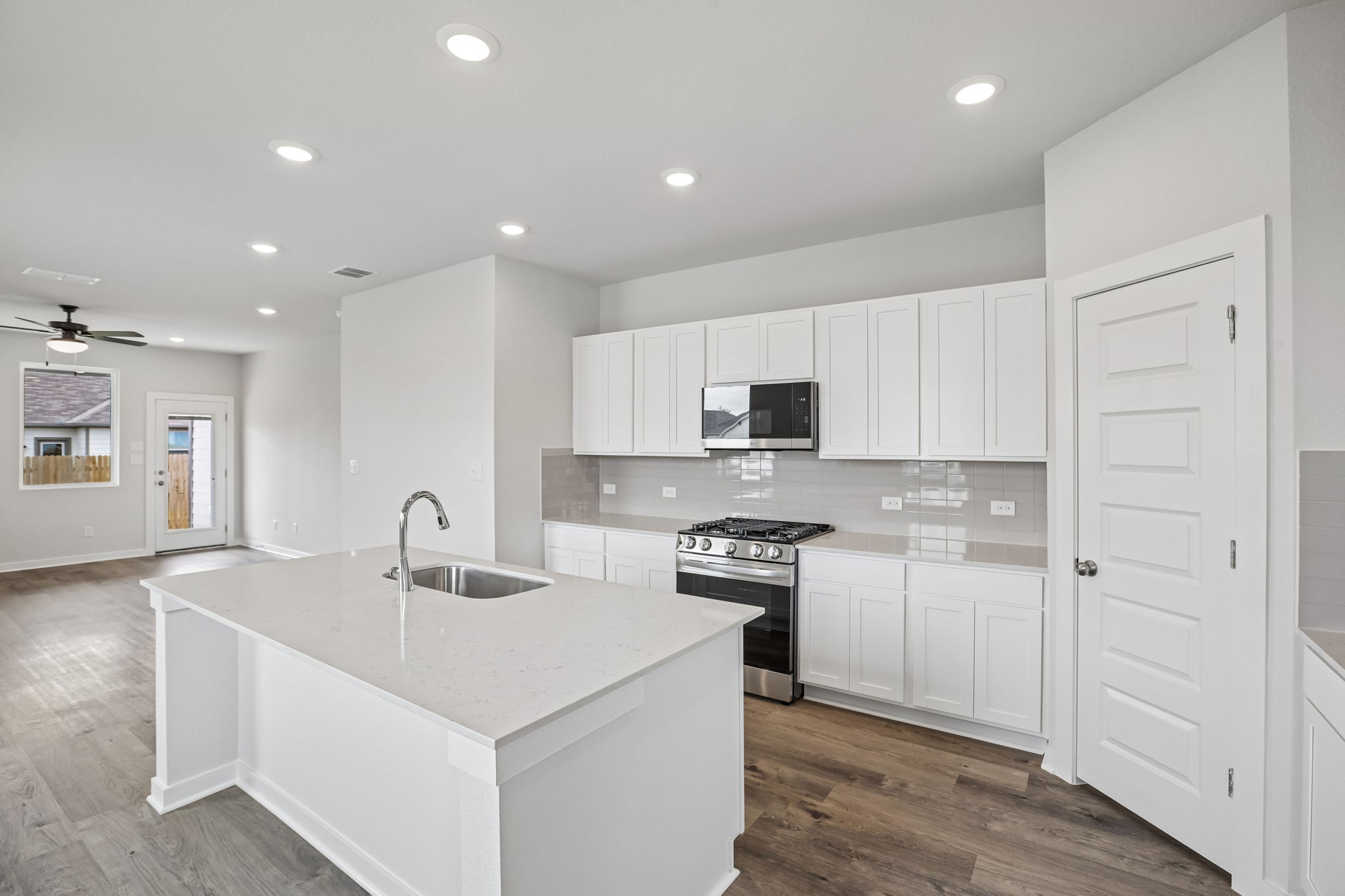 A kitchen with white cabinets.
