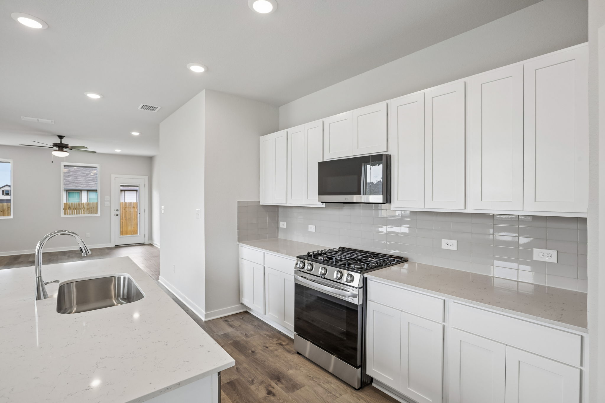 A kitchen with white cabinets.