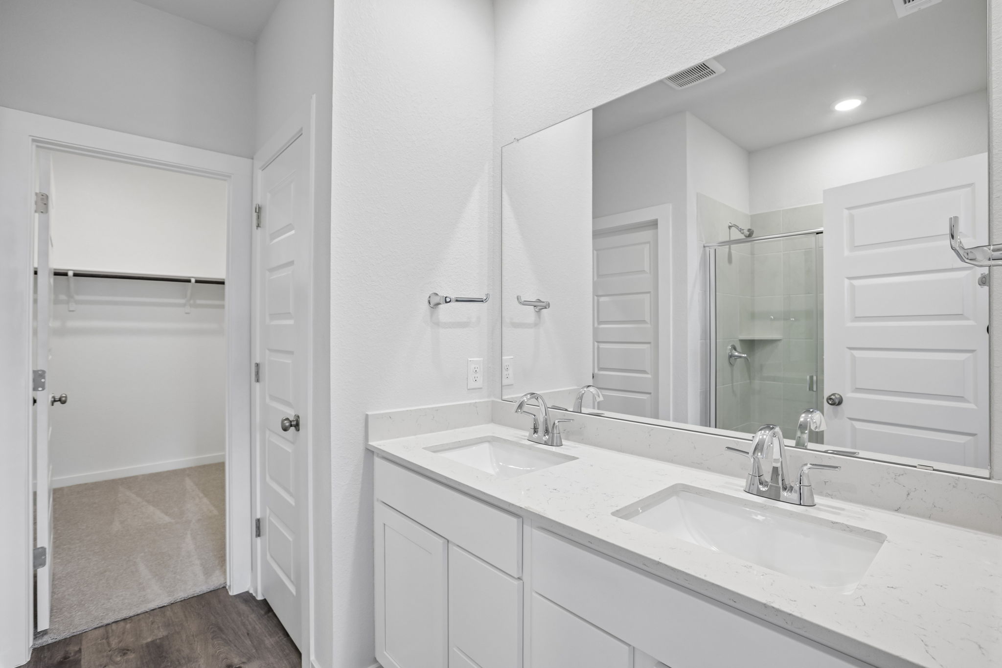 A bathroom with a large mirror.