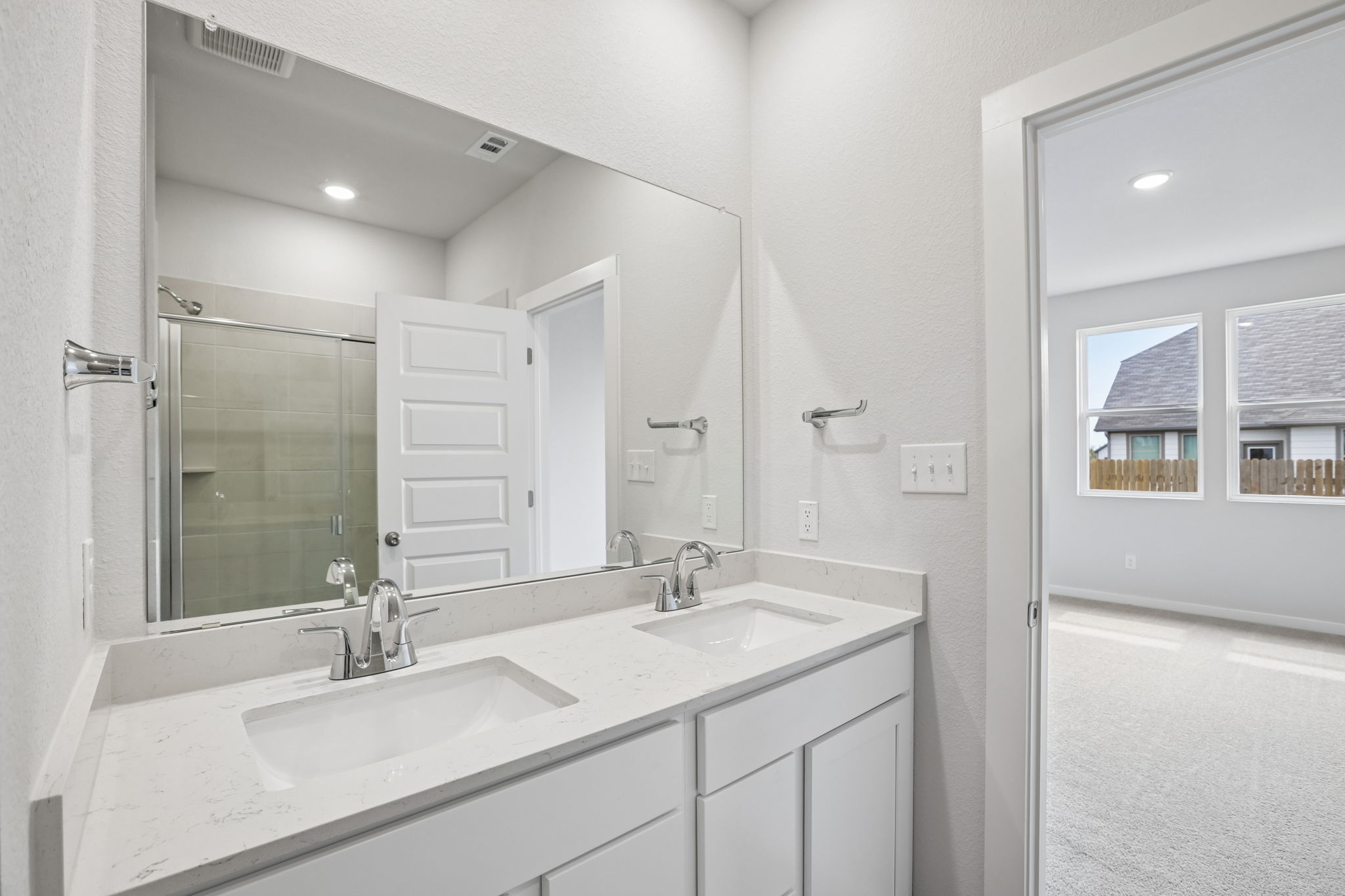 A bathroom with a large mirror.