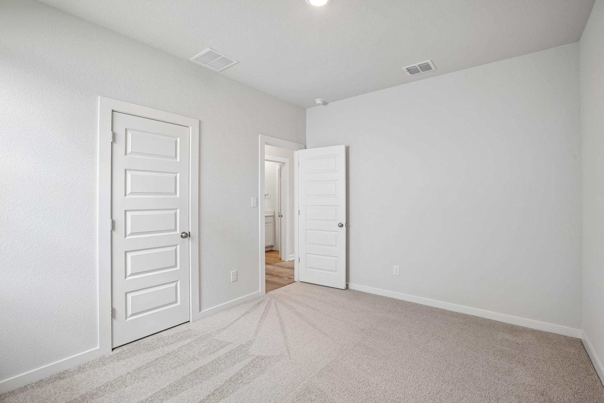 A hallway with white doors.