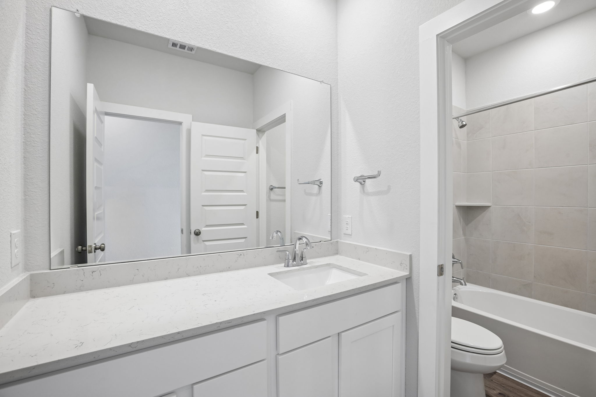A bathroom with a sink and a toilet.