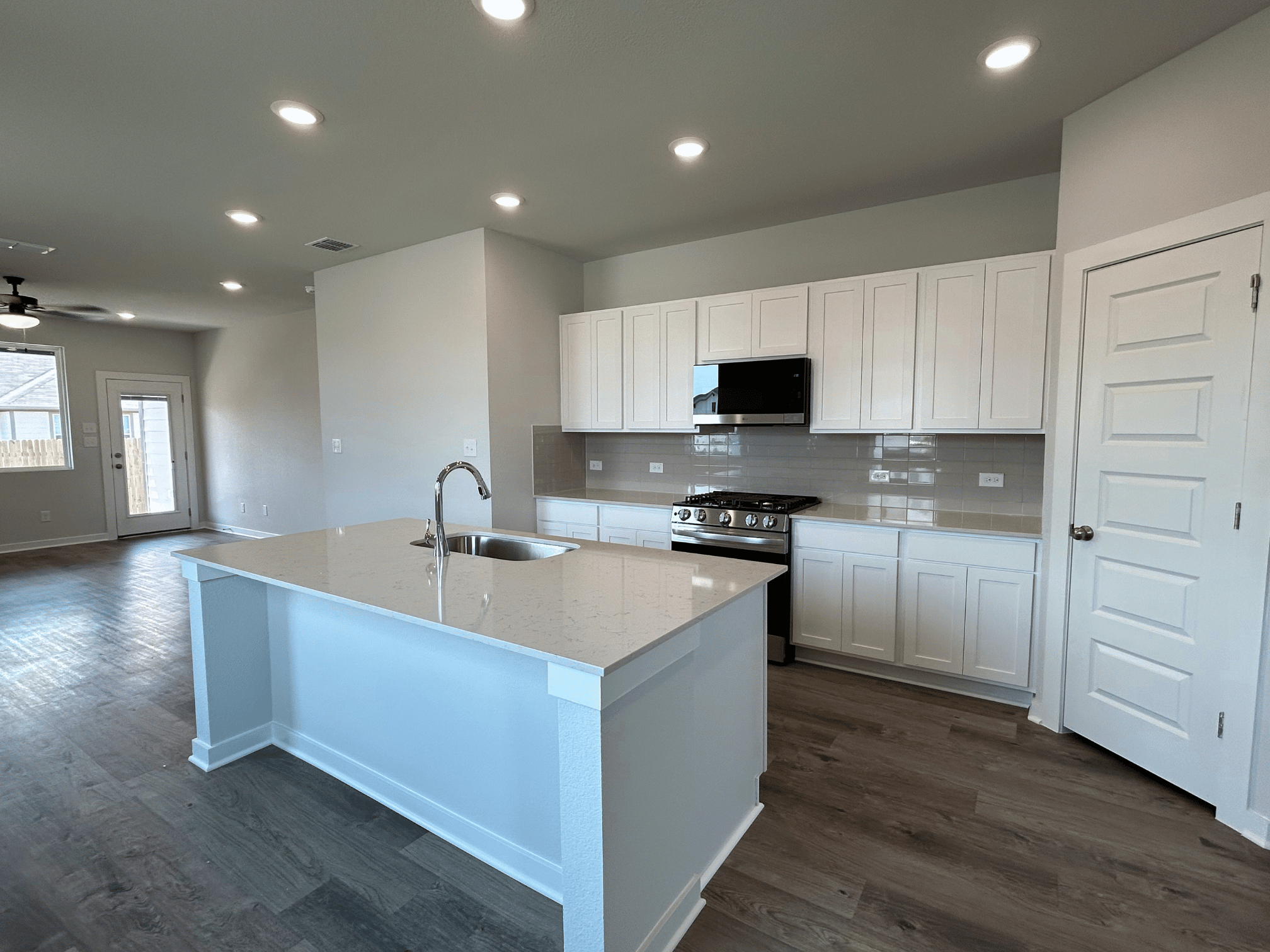 A kitchen with white cabinets.