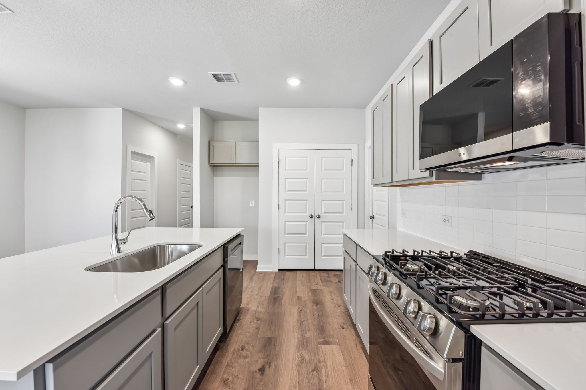 A kitchen with white cabinets.