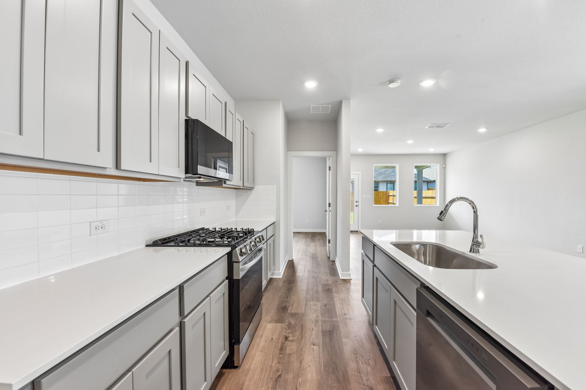 A kitchen with white cabinets.