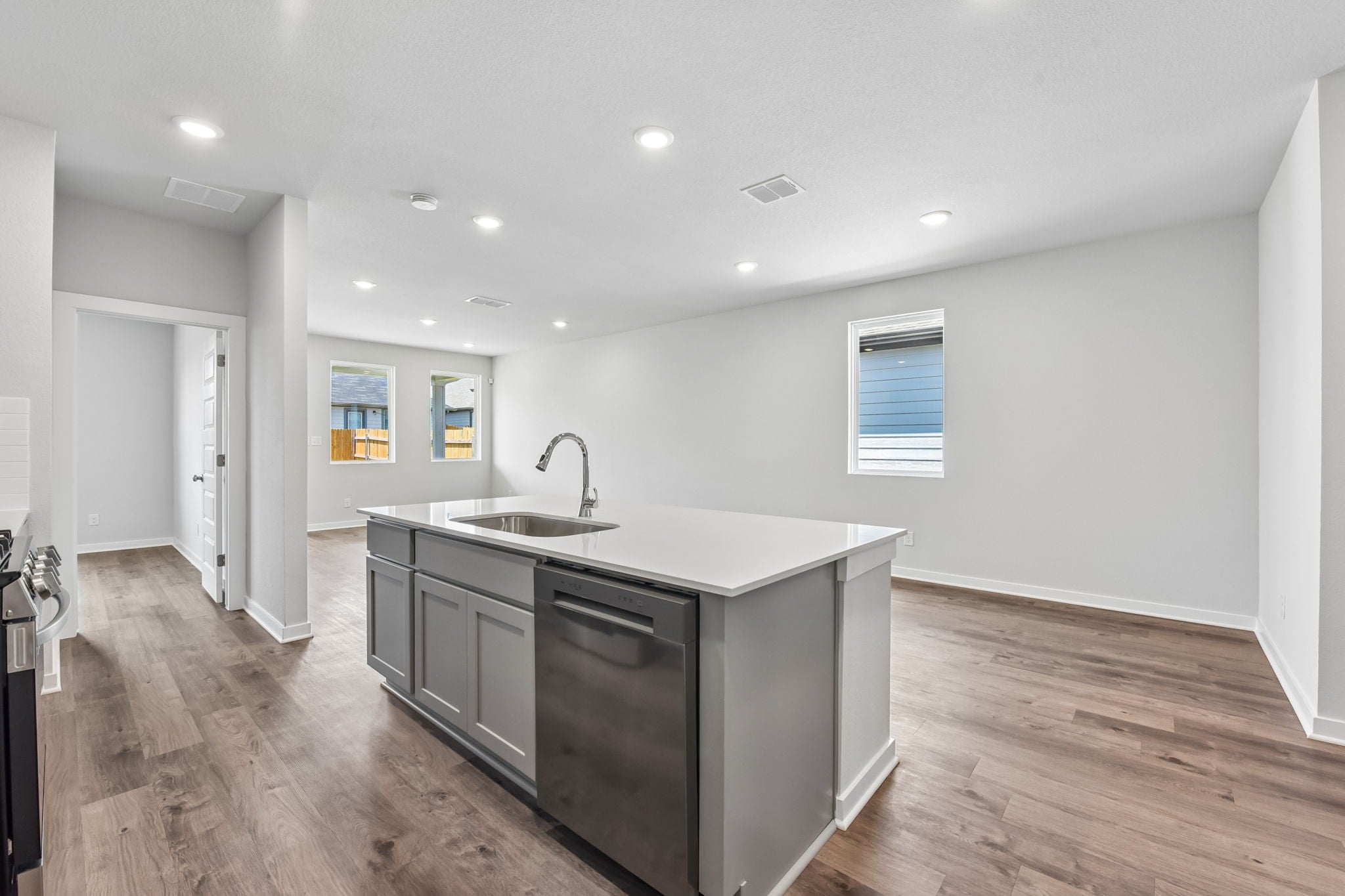 A kitchen with a wood floor.