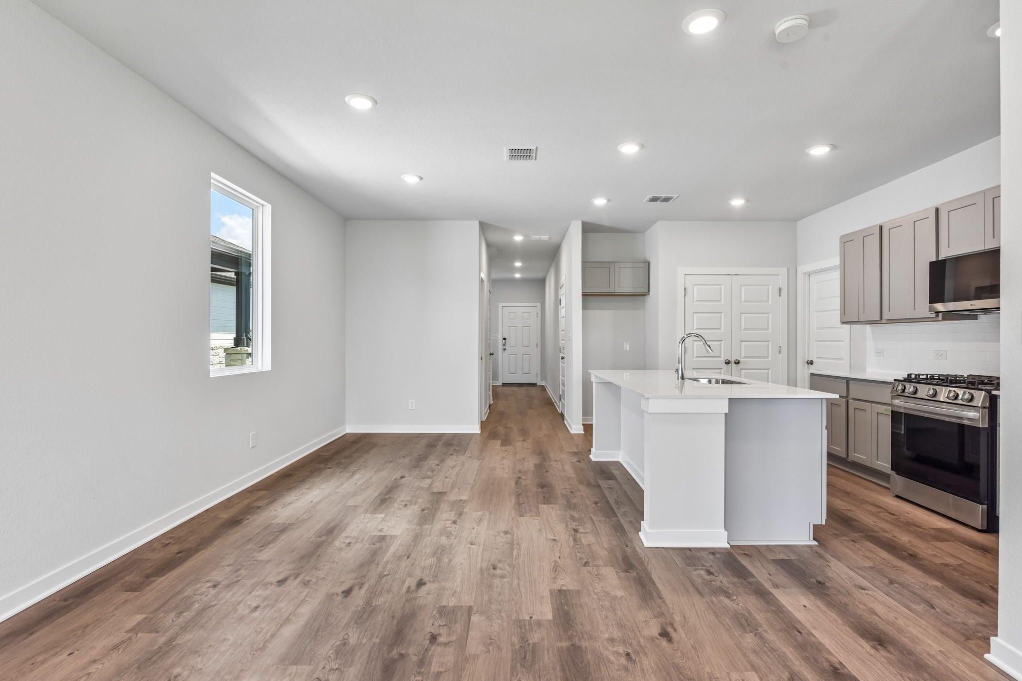 A kitchen with white cabinets.