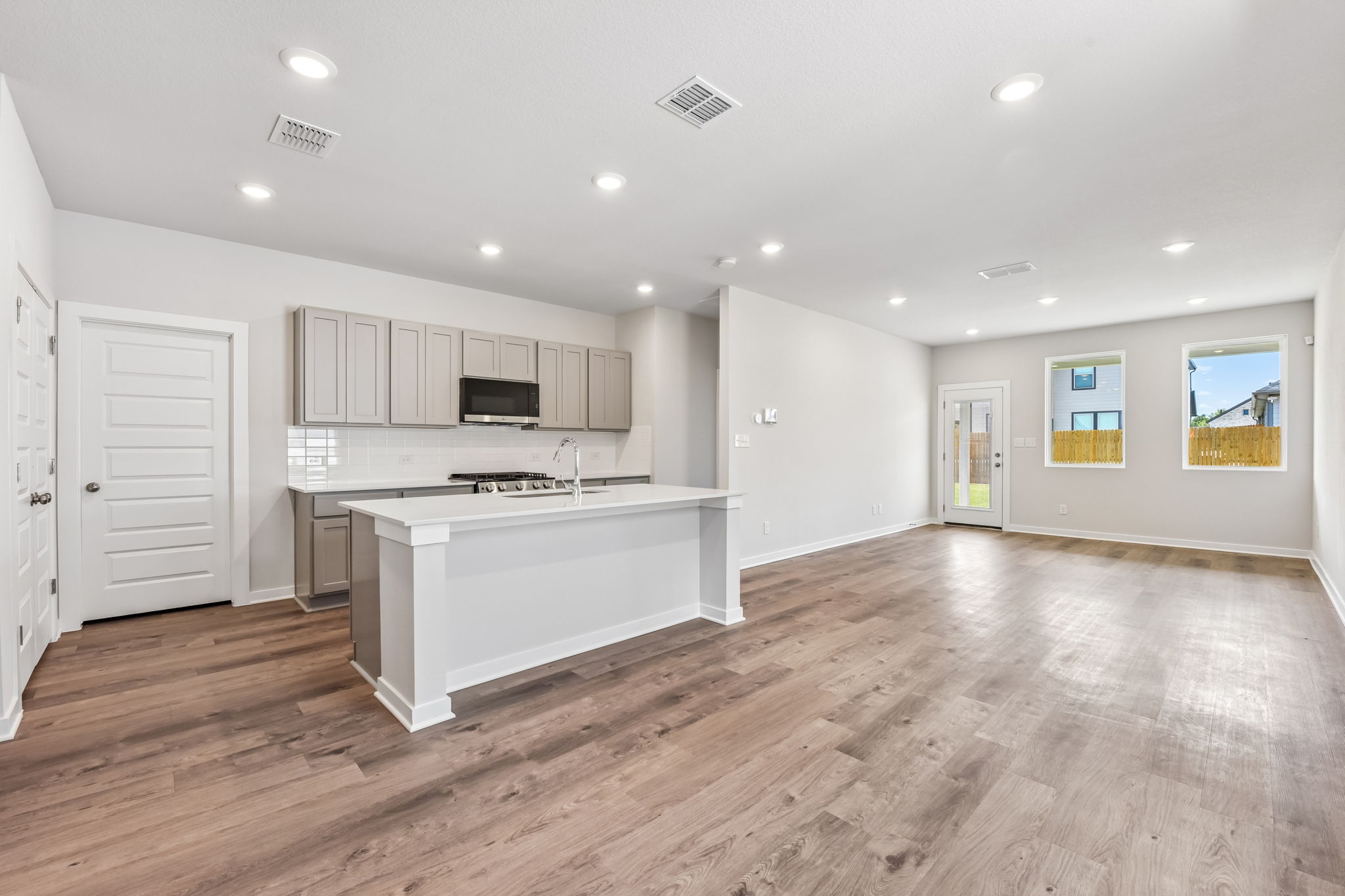 A large kitchen with white cabinets.