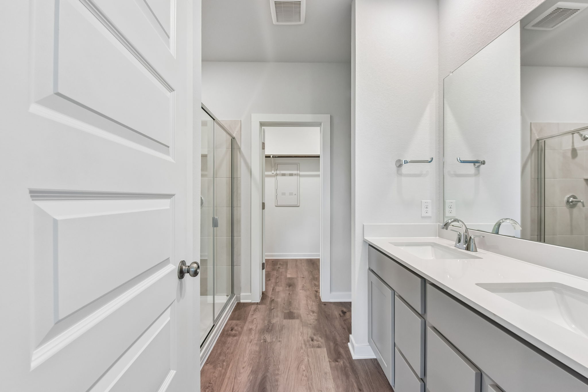 A bathroom with white cabinets.