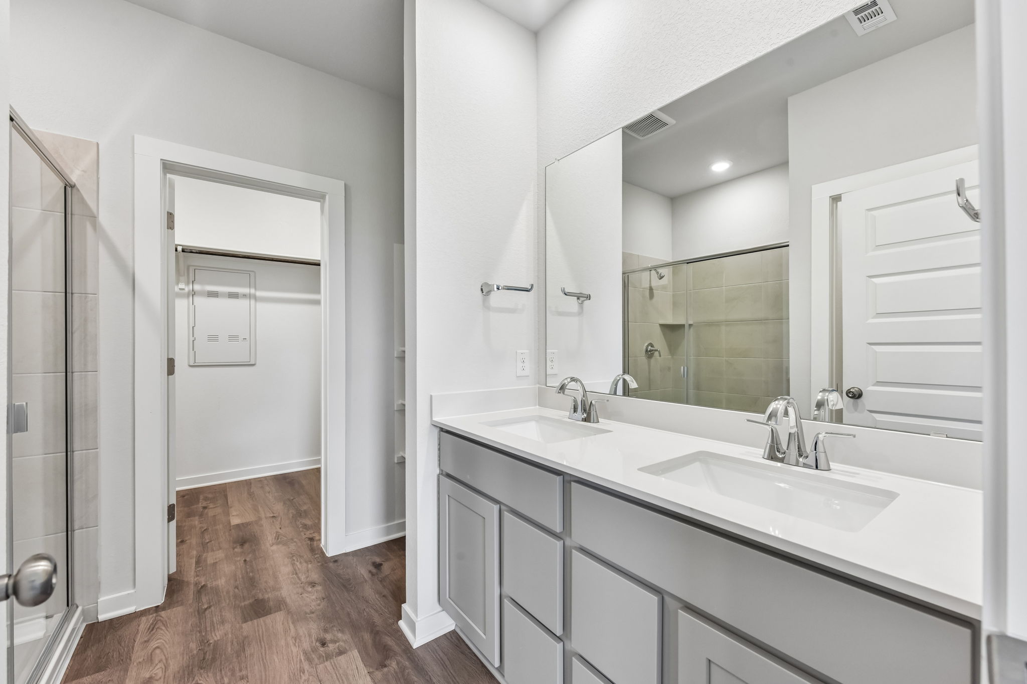A bathroom with a large mirror.