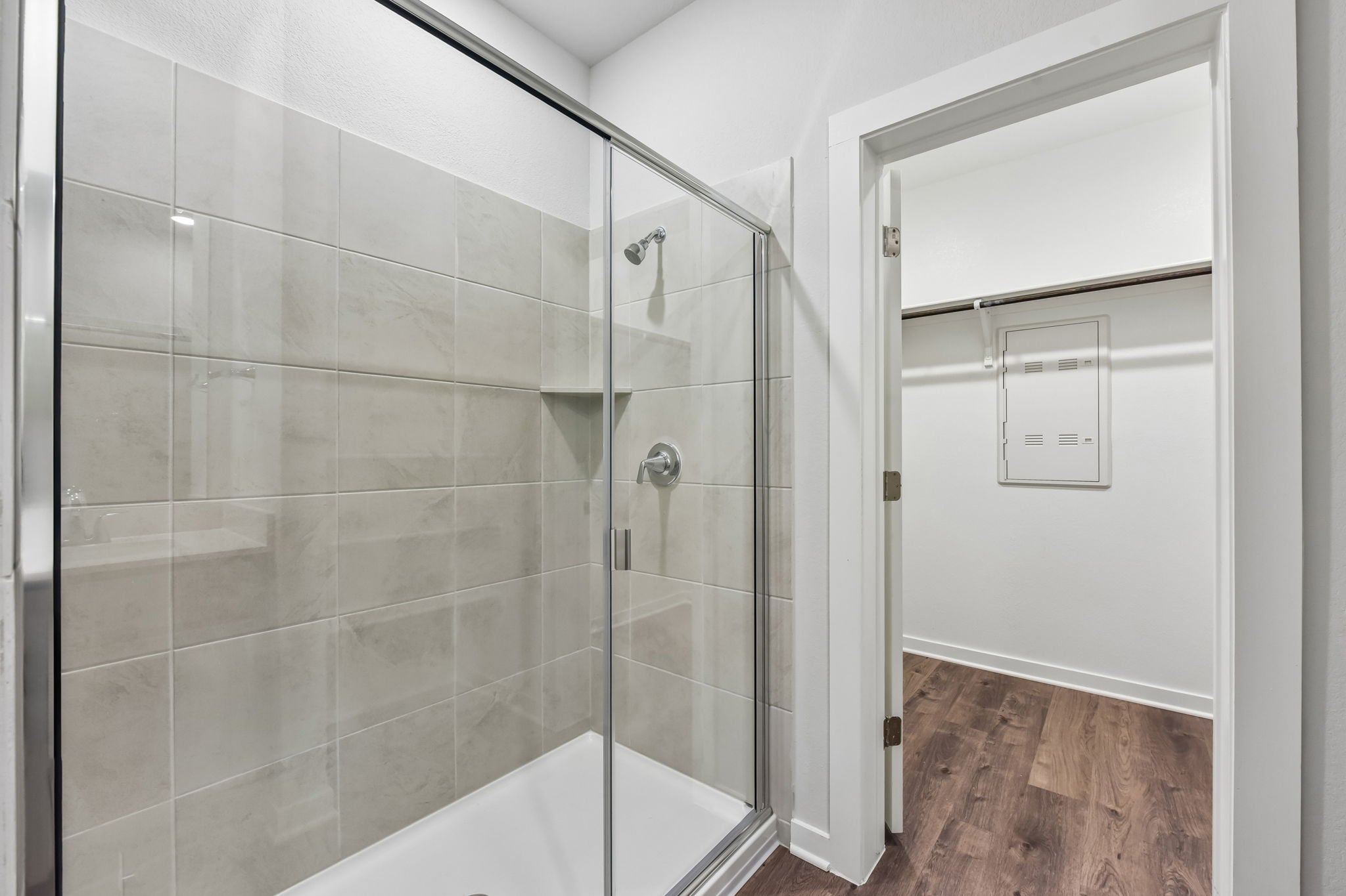 A shower with a glass door.