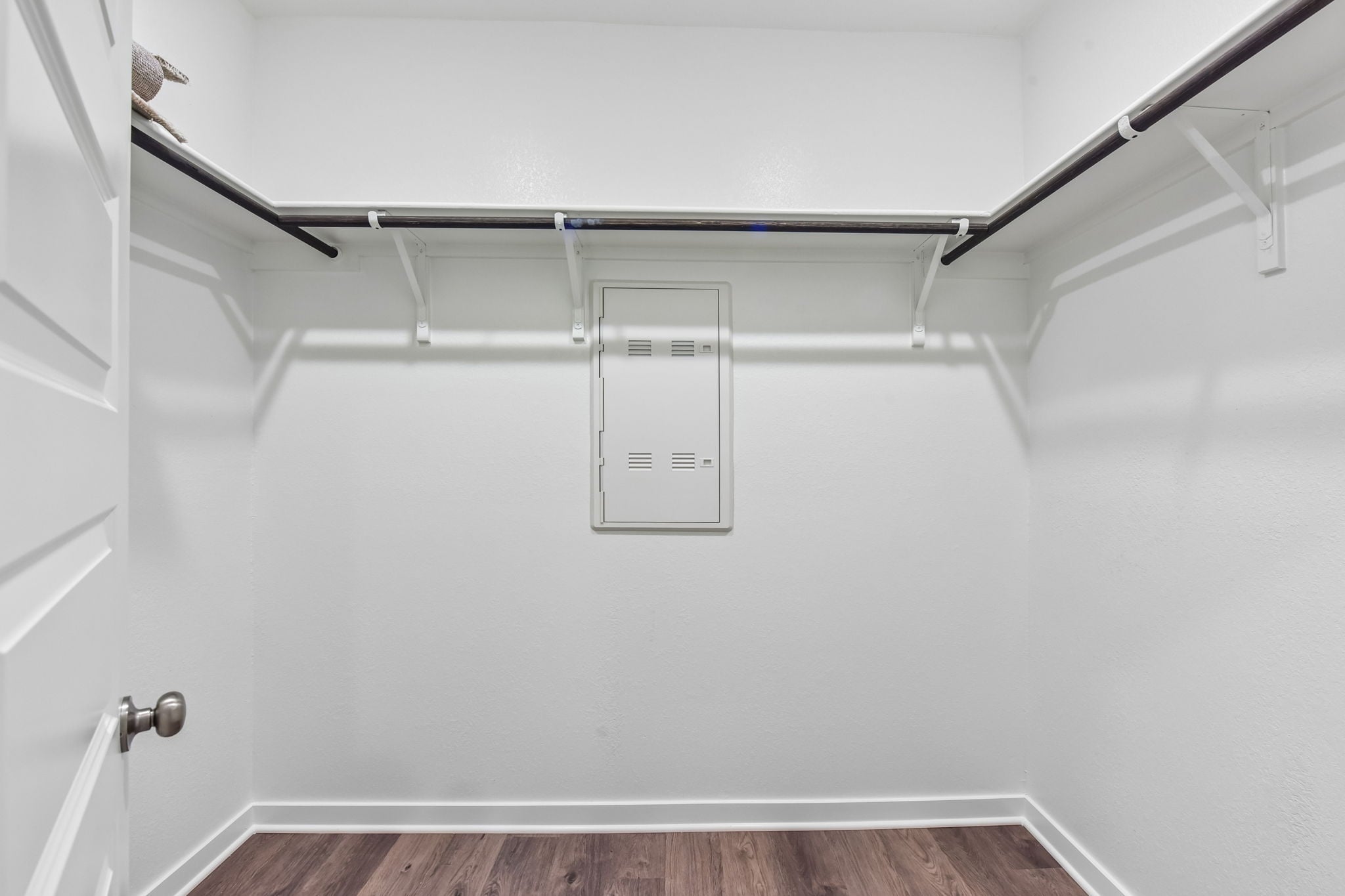 A white wall with a light fixture.